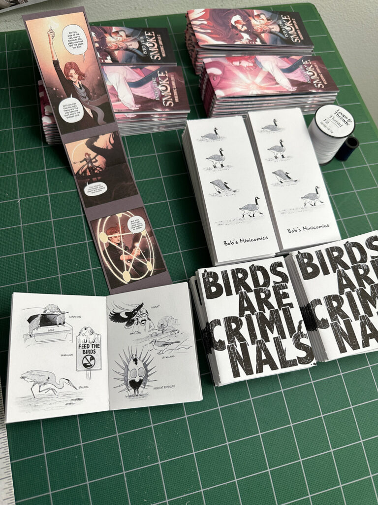 A preview of 4 zines: two vertical Into the Smoke sampler zines, one vertical Bob's Minicomics zine, and one square Birds are Criminals zine.